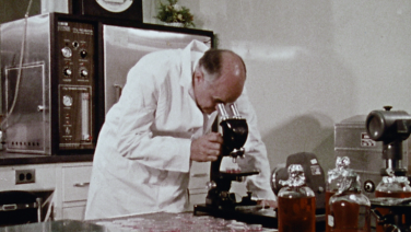 Dr. Hilleman and microscope